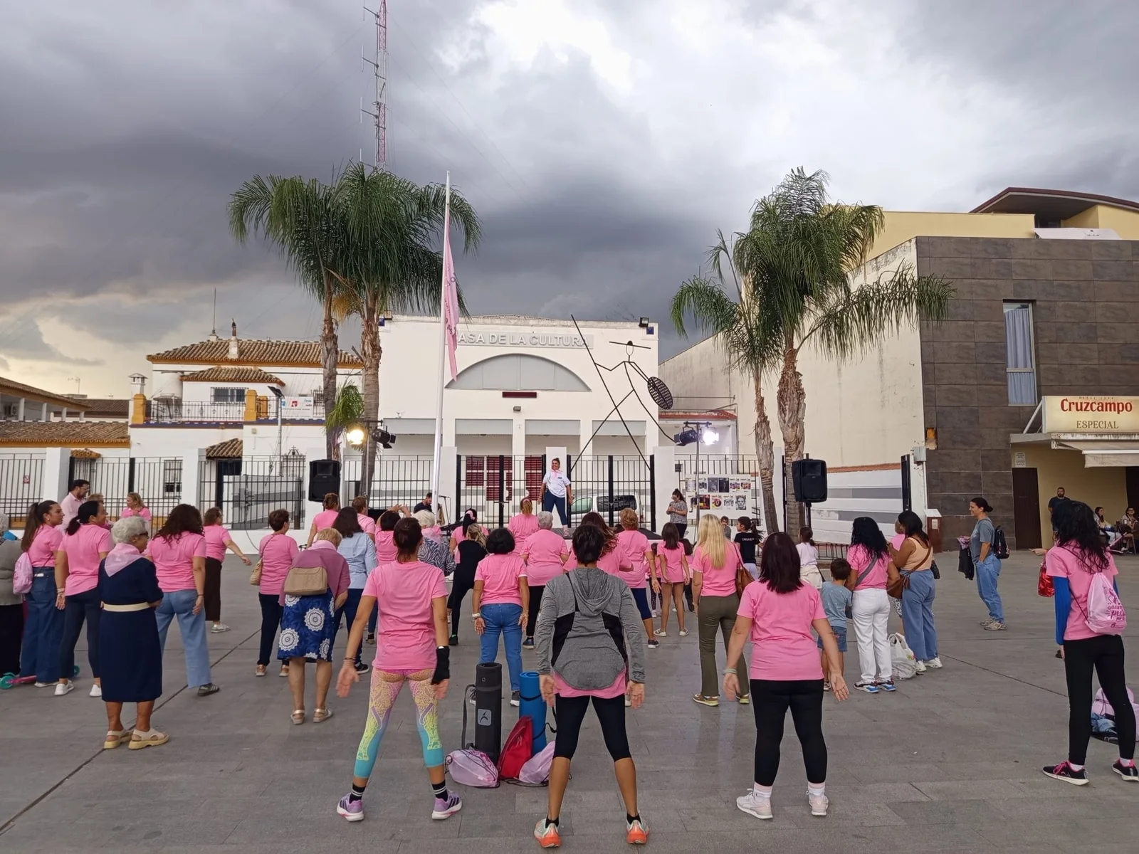 Mujeres con camisetas rosas haciendo ejercicio en la plaza de la Cultura de Guillena