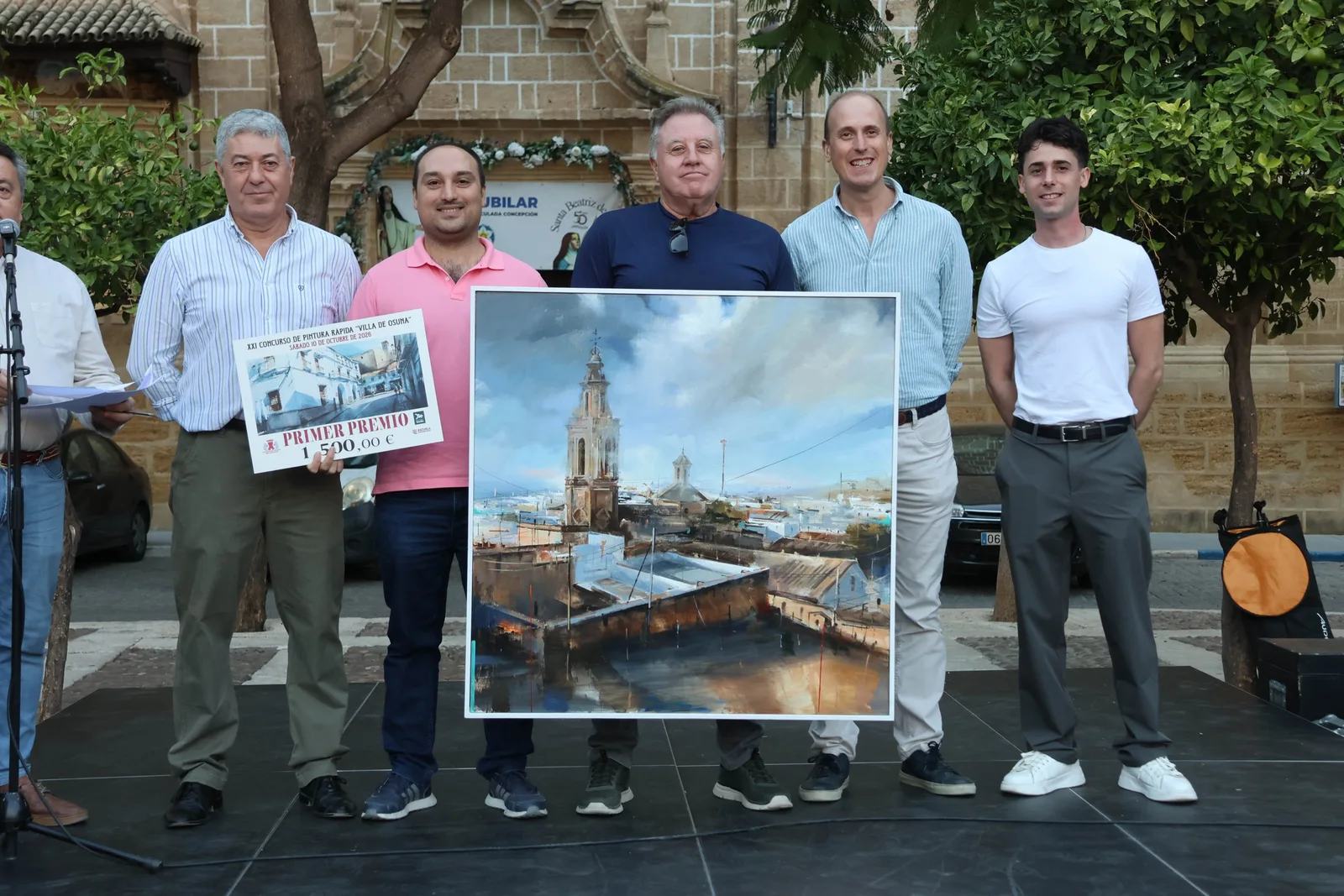 Juan Lucena Orellana receives first prize in the Villa de Osuna Speed Painting Competition beside his work